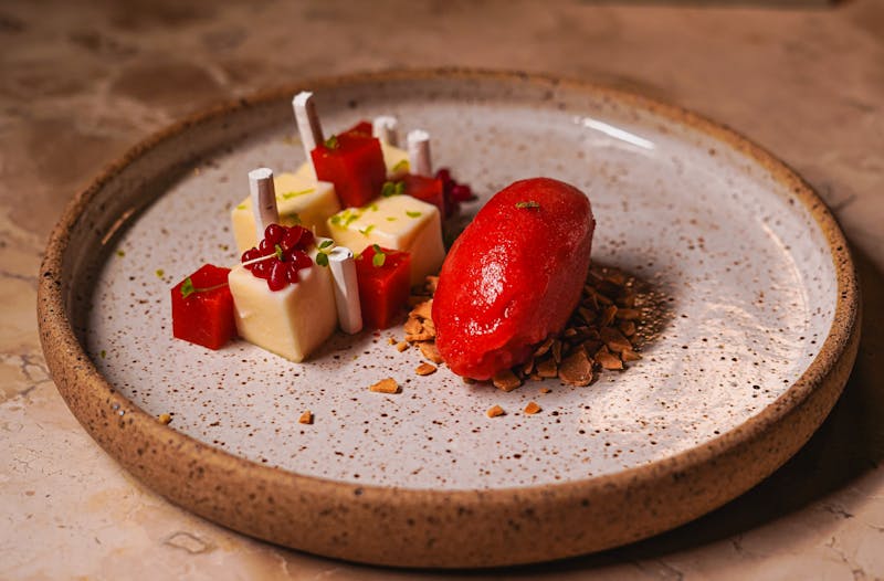 Talented head pastry chef presenting signature desserts at Pequod's