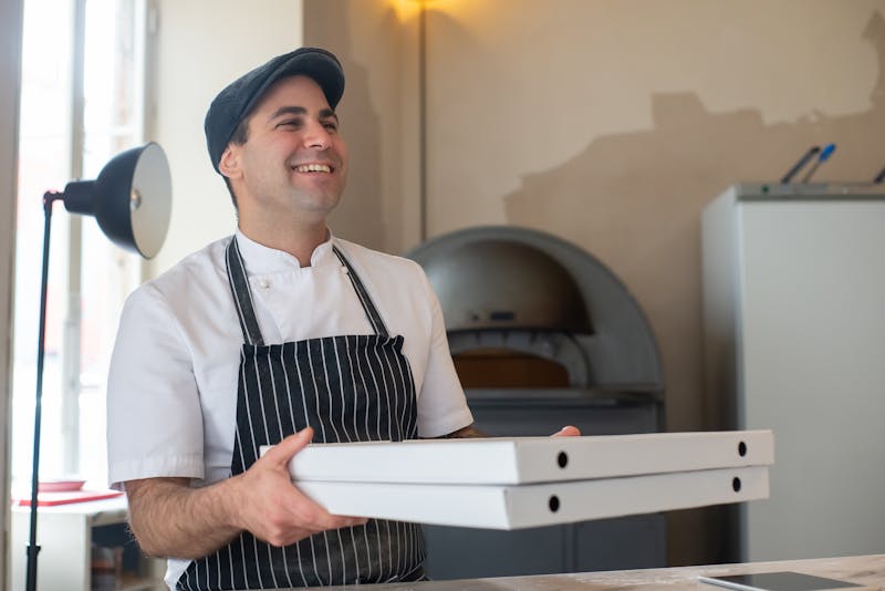 Skilled Pequod's pizza chef crafting the perfect deep dish in the kitchen